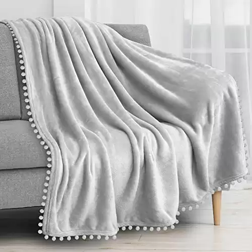PAVILIA Light Gray Throw Blanket Pom Pom Couch Bed Sofa, Fleece Soft Fuzzy Cozy Lightweight Pompom Fringe Blanket, Decorative Boho Room Home Decor Gift Flannel Velvet Throw, Silver Light Grey, 50x60